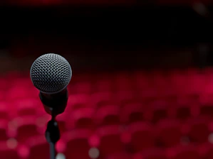 a microphone on a stand in front of a red background