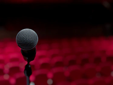 a microphone on a stand in front of a red background
