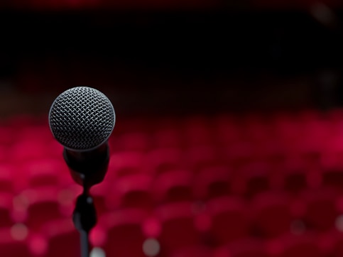 a microphone on a stand in front of a red background