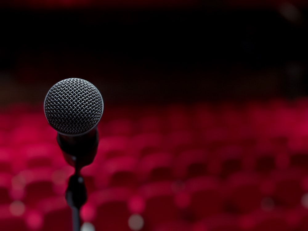 a microphone on a stand in front of a red background