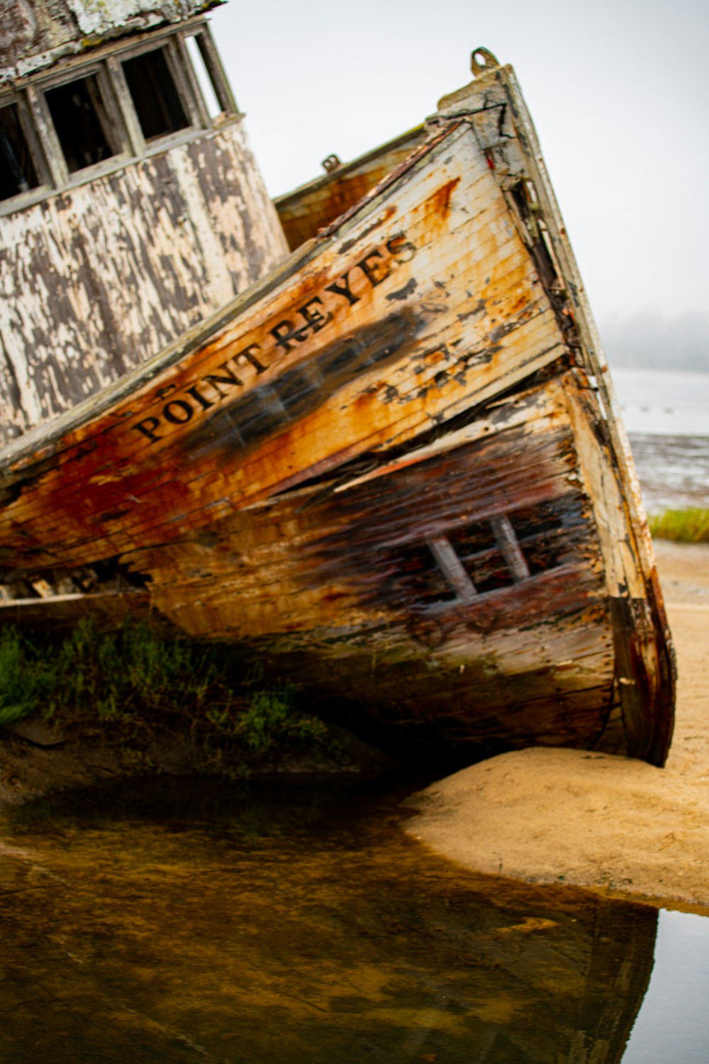 brown and white wooden boat on body of water during daytime