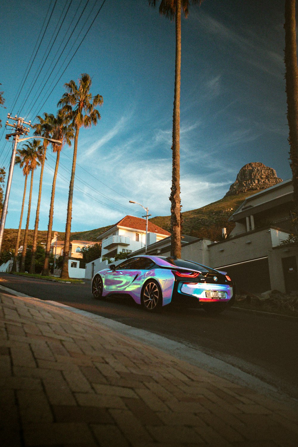 purple coupe parked on sidewalk during daytime