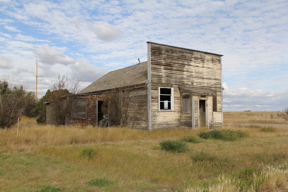 an old run down building in a field
