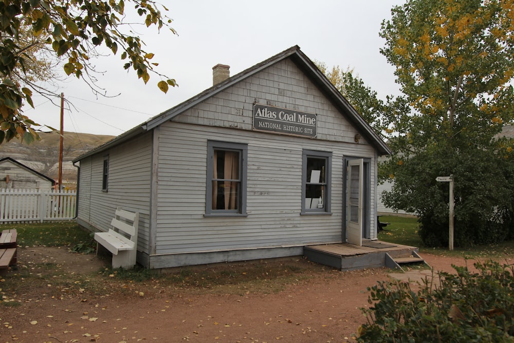 a small building with a bench in front of it