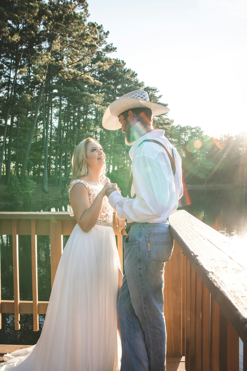 man and woman standing on wooden dock during daytime