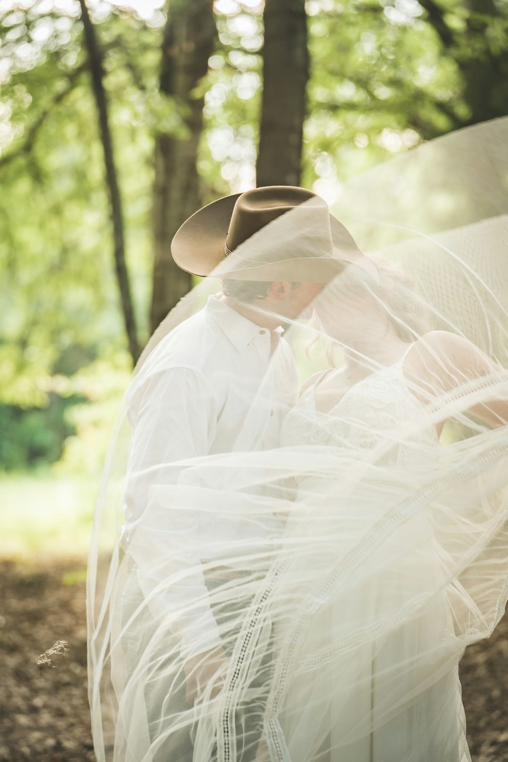 woman in white wedding dress and white veil