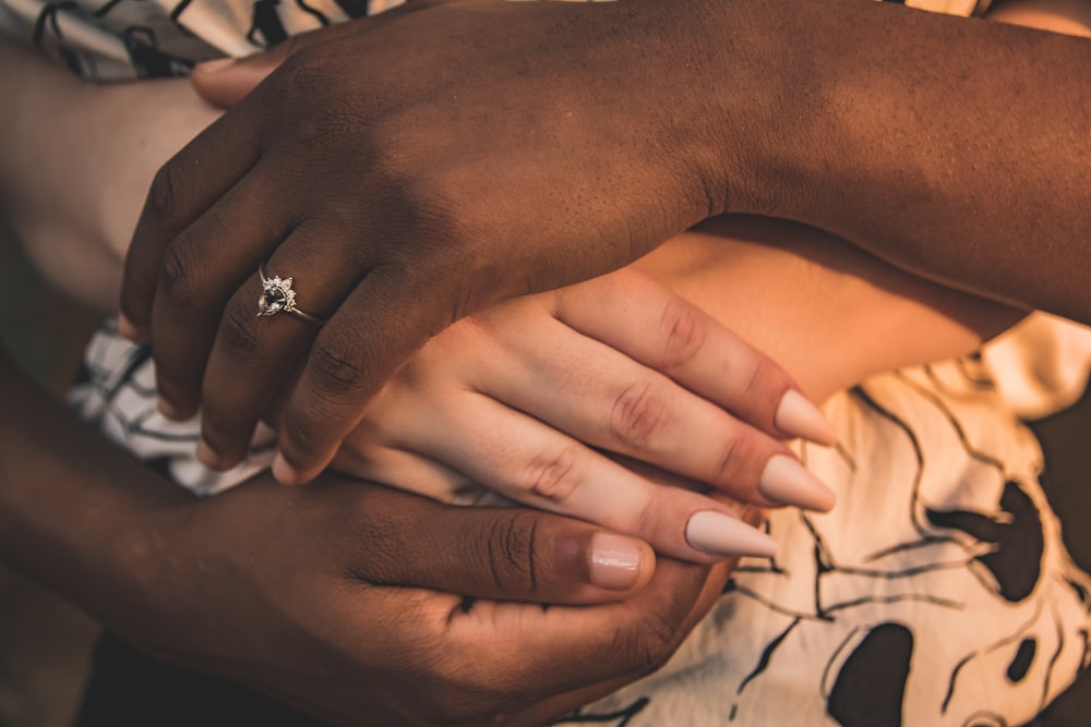 person wearing silver diamond ring