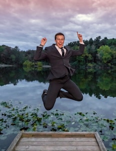 a man in a suit jumping into the air