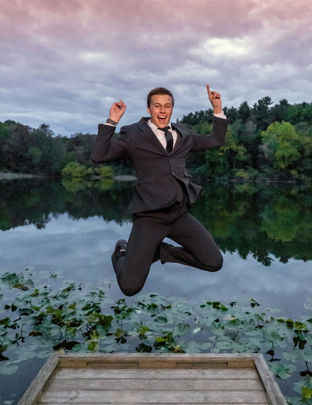 a man in a suit jumping into the air