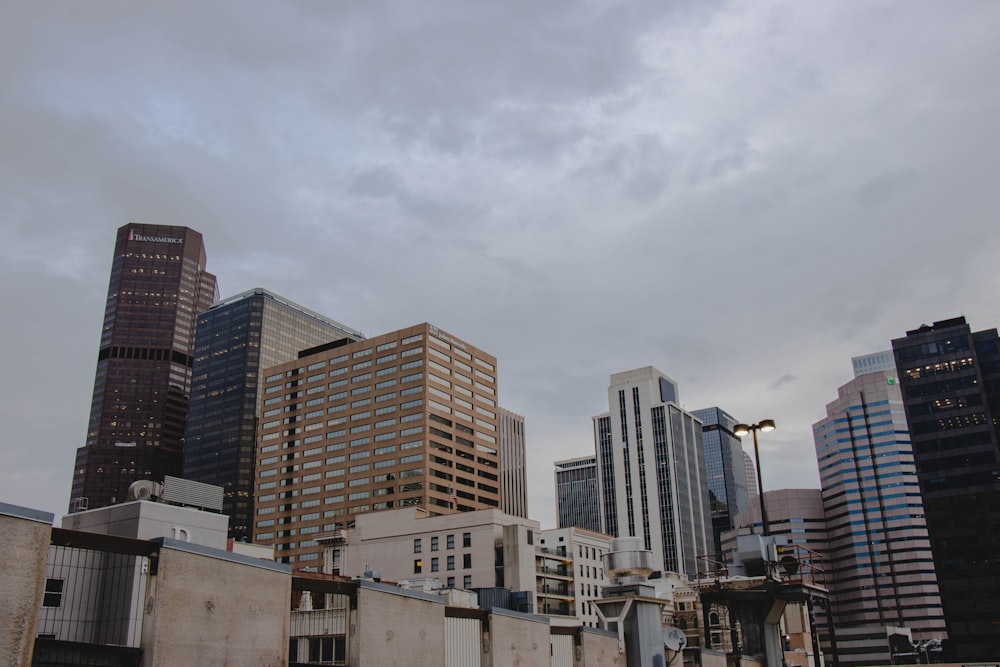 white and brown concrete buildings under white clouds during daytime