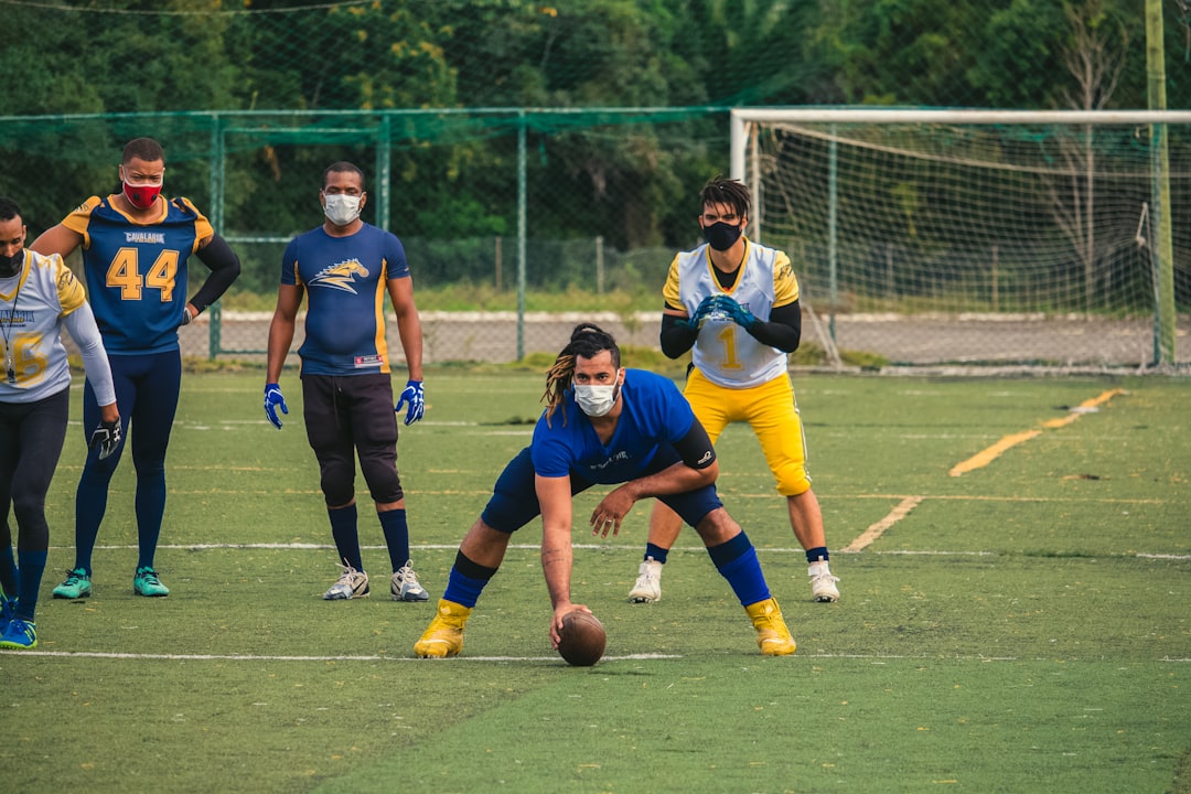 woman in blue and white jersey shirt playing soccer during daytime