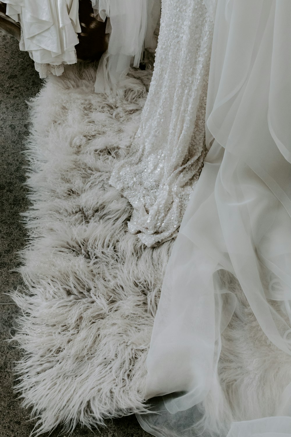 white floral wedding gown on gray textile