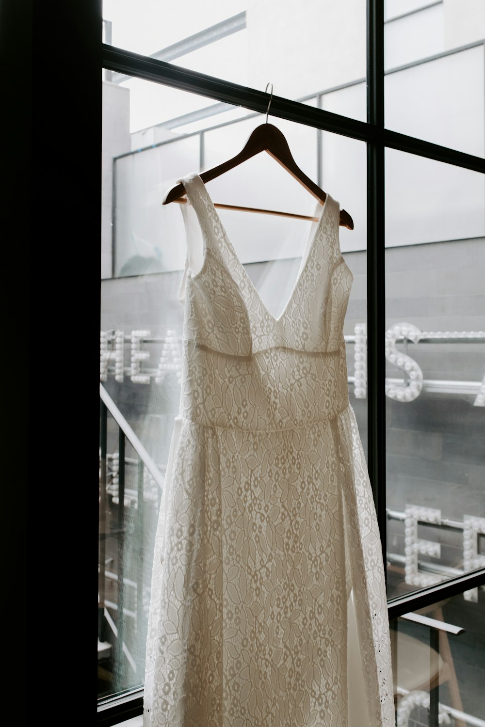 white sleeveless dress on clothes hanger