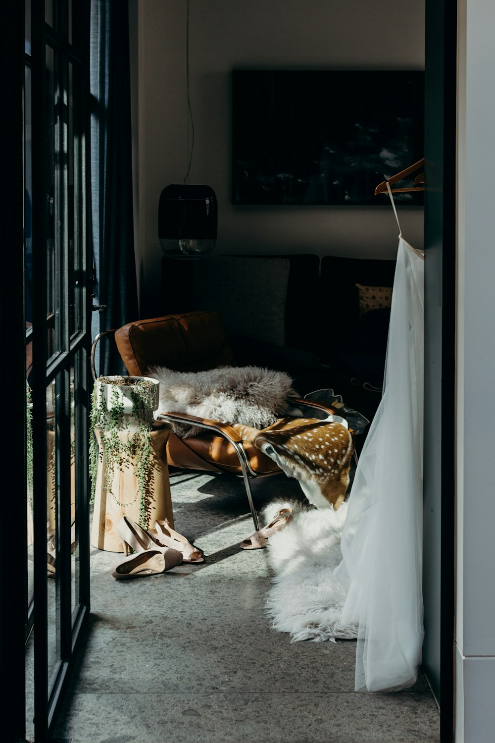 woman in black leather peep toe heeled sandals sitting on brown wooden armchair