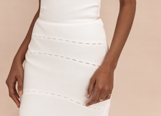 woman in white spaghetti strap dress