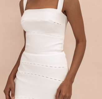 woman in white spaghetti strap dress