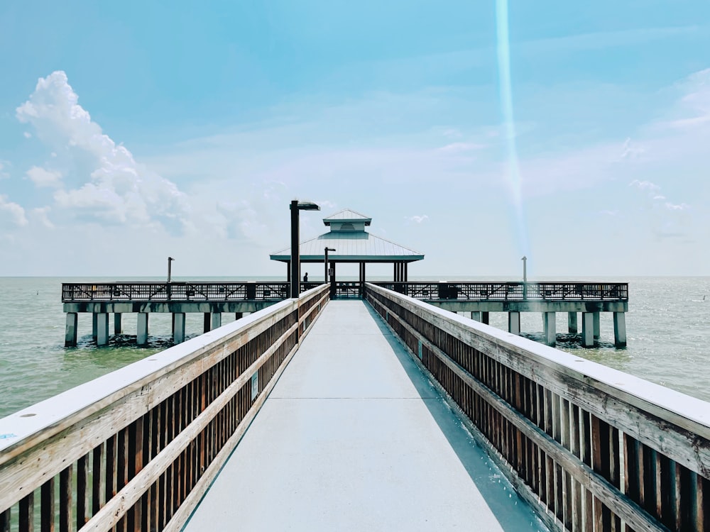 brown wooden bridge under blue sky during daytime