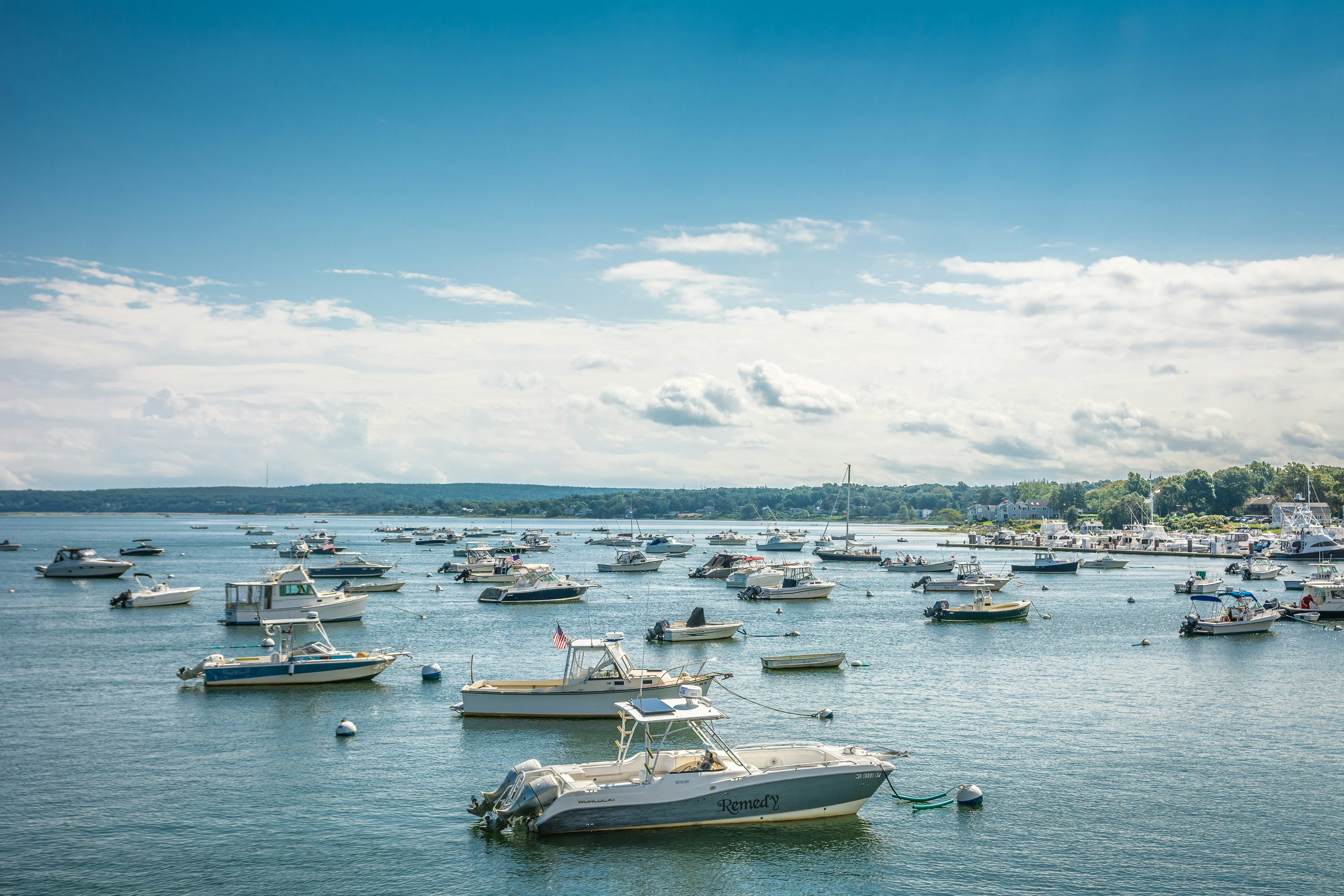 white and blue boat on sea under blue sky during daytime plymouth teams background