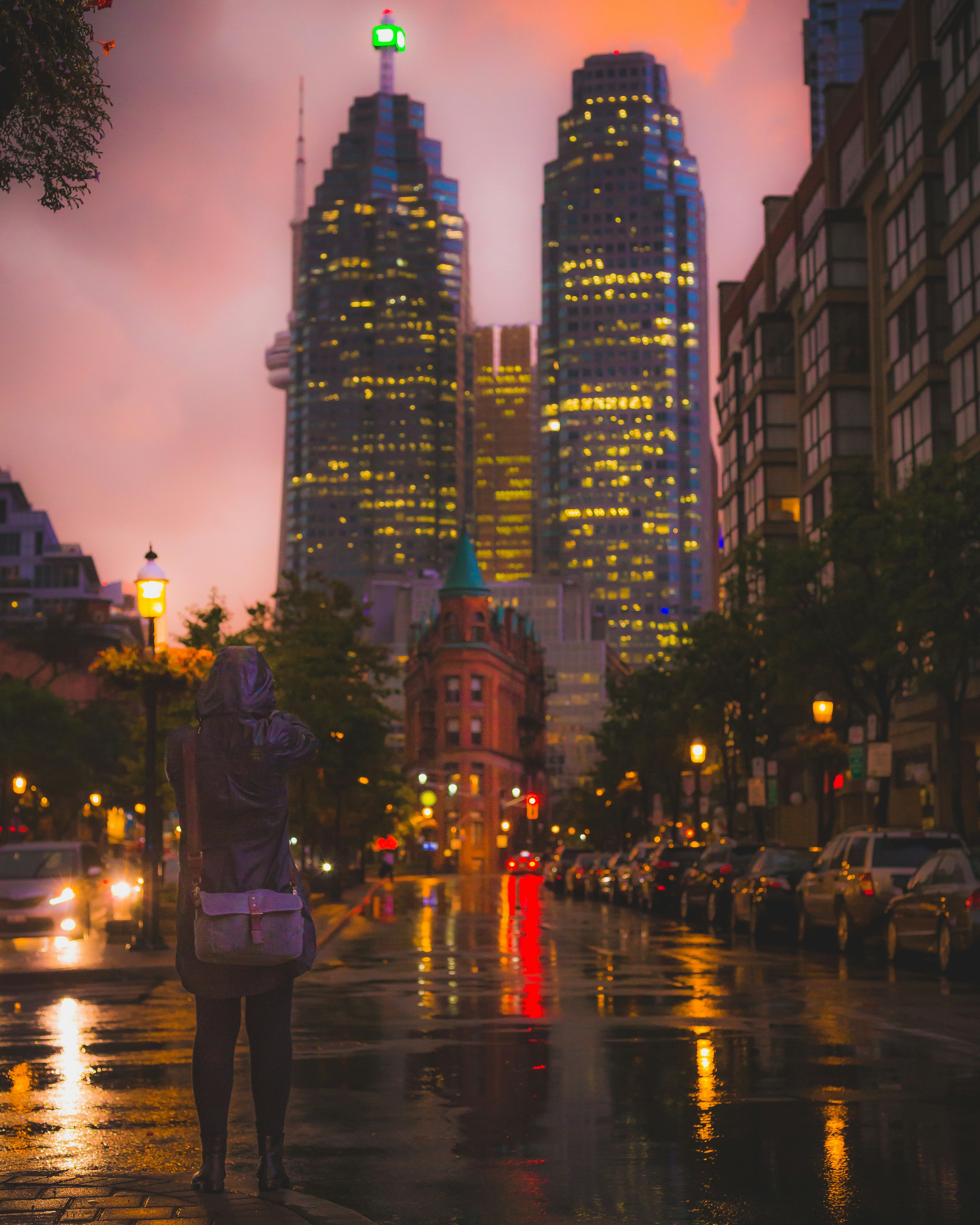 Street photo of person in oversized hoodie in urban environment, moody city lighting