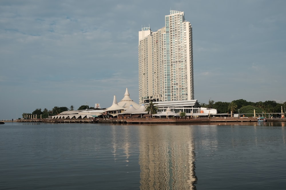 white and brown boat on water near city buildings during daytime