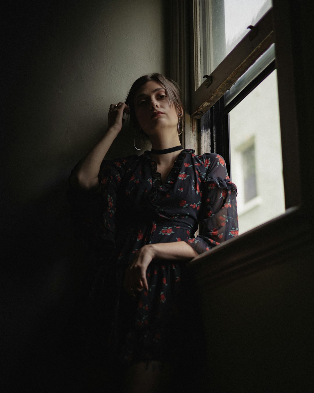 woman in red and black floral dress sitting on chair