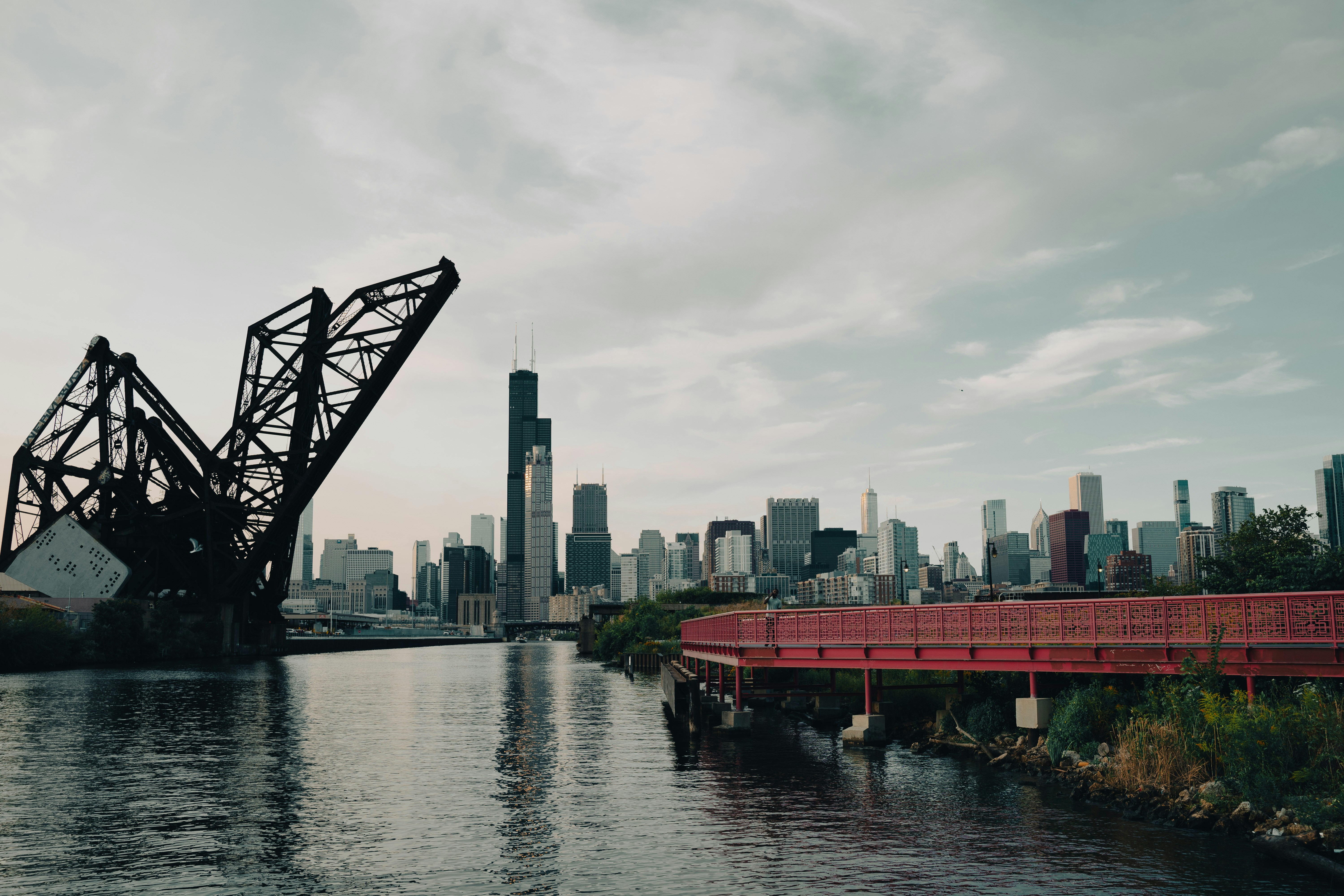 red bridge over river during daytime, Chicago River in late summer