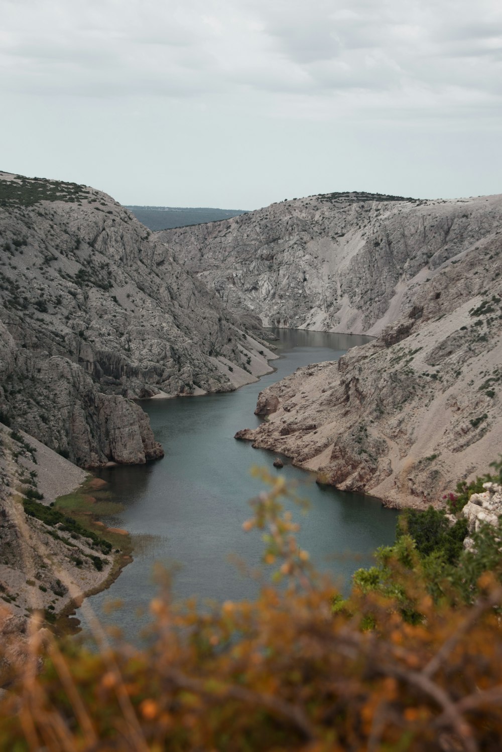 river between mountains during daytime