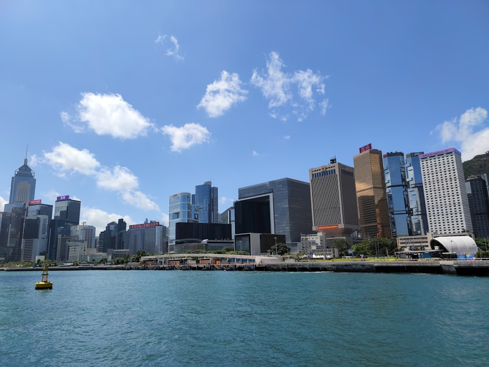 city buildings near body of water under blue sky during daytime