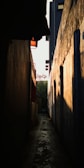 A quiet alleyway bathed in early morning light, with faint audio waveforms overlaid.
