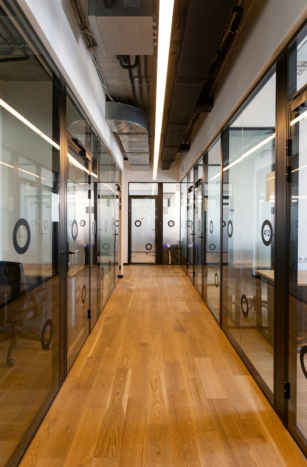 brown wooden floor and black metal doors