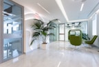 A modern office space with spotless desks and plants, showcasing a professional commercial cleaning service.