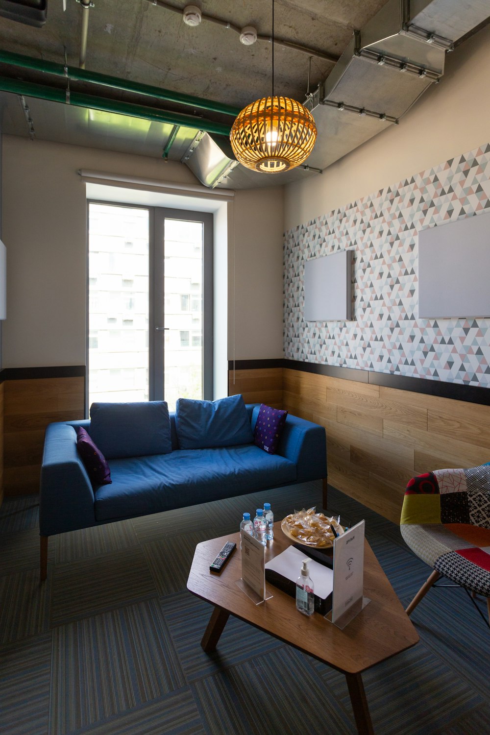 blue sofa near brown wooden table