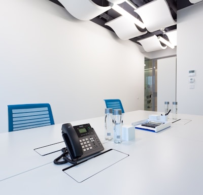 black ip desk phone on white table