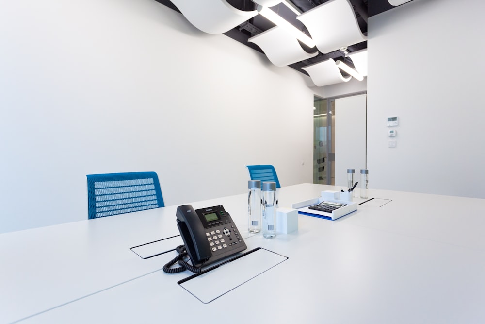 black ip desk phone on white table