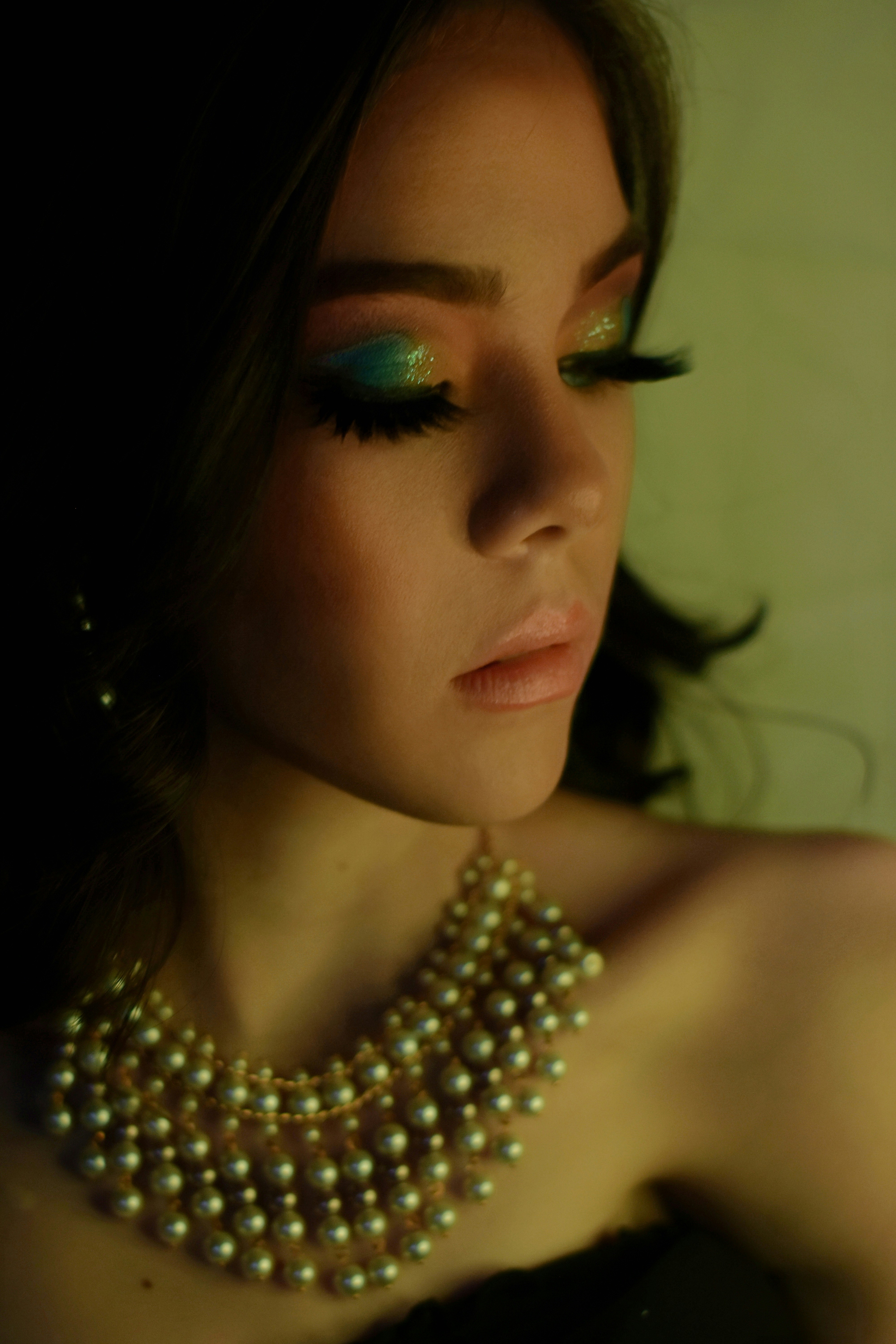 woman wearing silver necklace and silver earrings