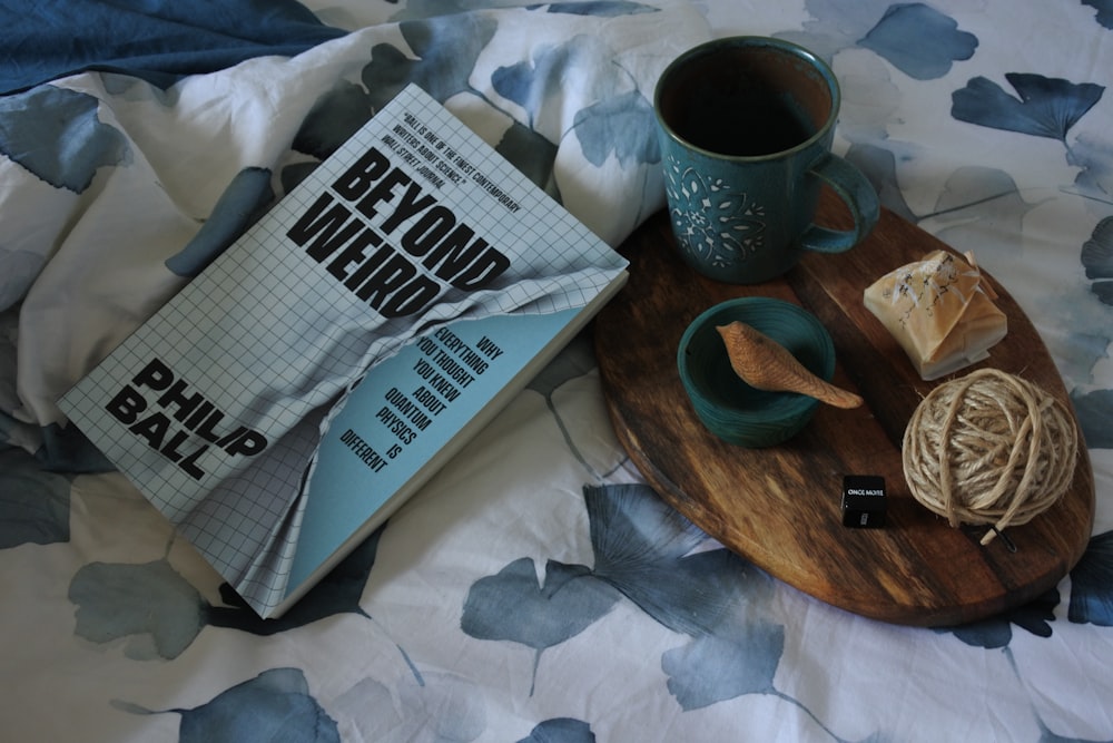 white and black ceramic mug on brown wooden coaster