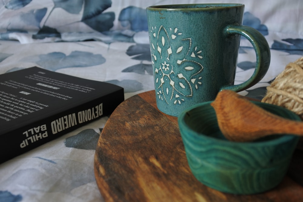 blue and white ceramic mug on brown wooden table