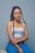 woman in white tank top and blue denim jeans