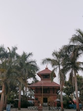 A serene Hindu temple with priests performing traditional rituals under a clear sky.