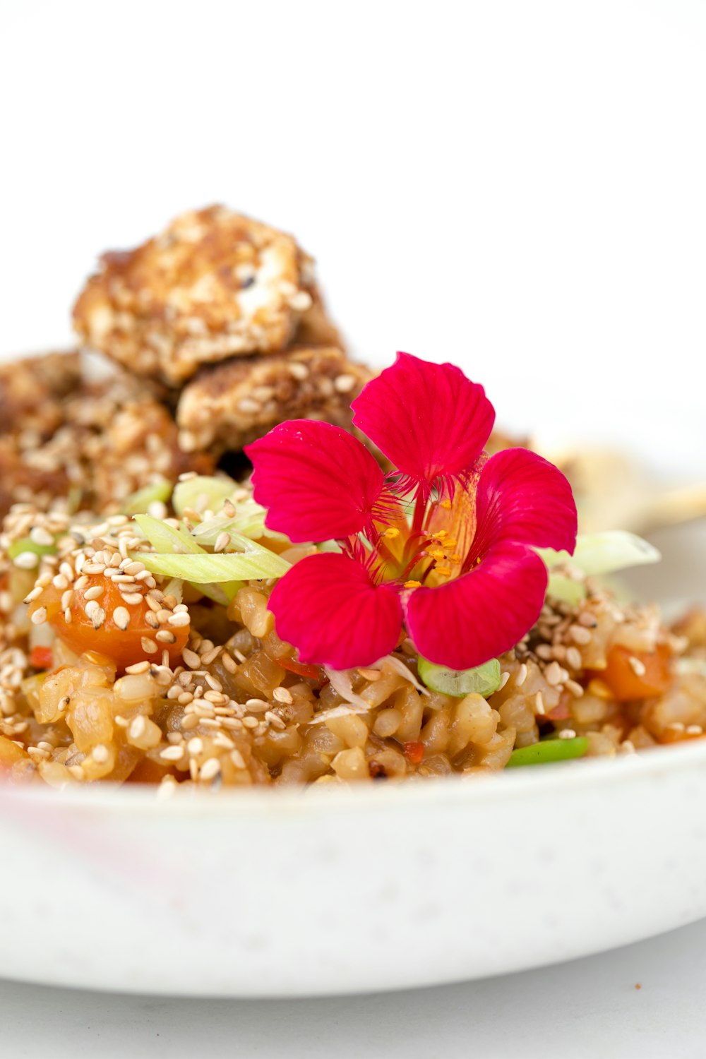 brown bread with white and pink flower on white ceramic plate