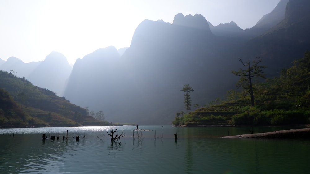 body of water near mountain during daytime