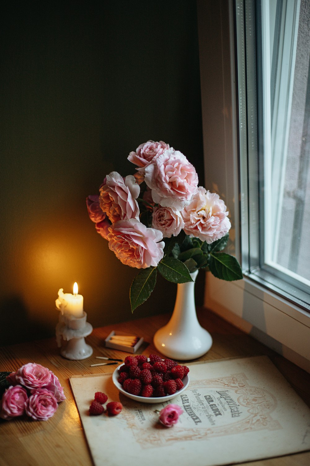 pink roses in white ceramic vase