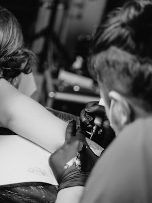 grayscale photo of man and woman kissing