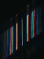 a dark room with a wall of multicolored lights