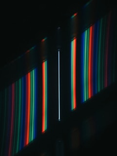 a dark room with a wall of multicolored lights