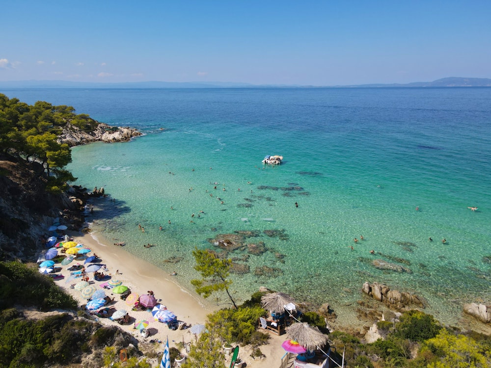 uma praia cheia de muita gente e guarda-sóis