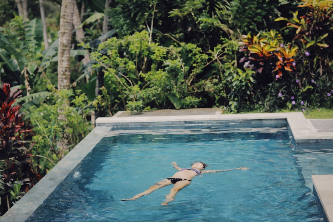 woman in swimming pool during daytime