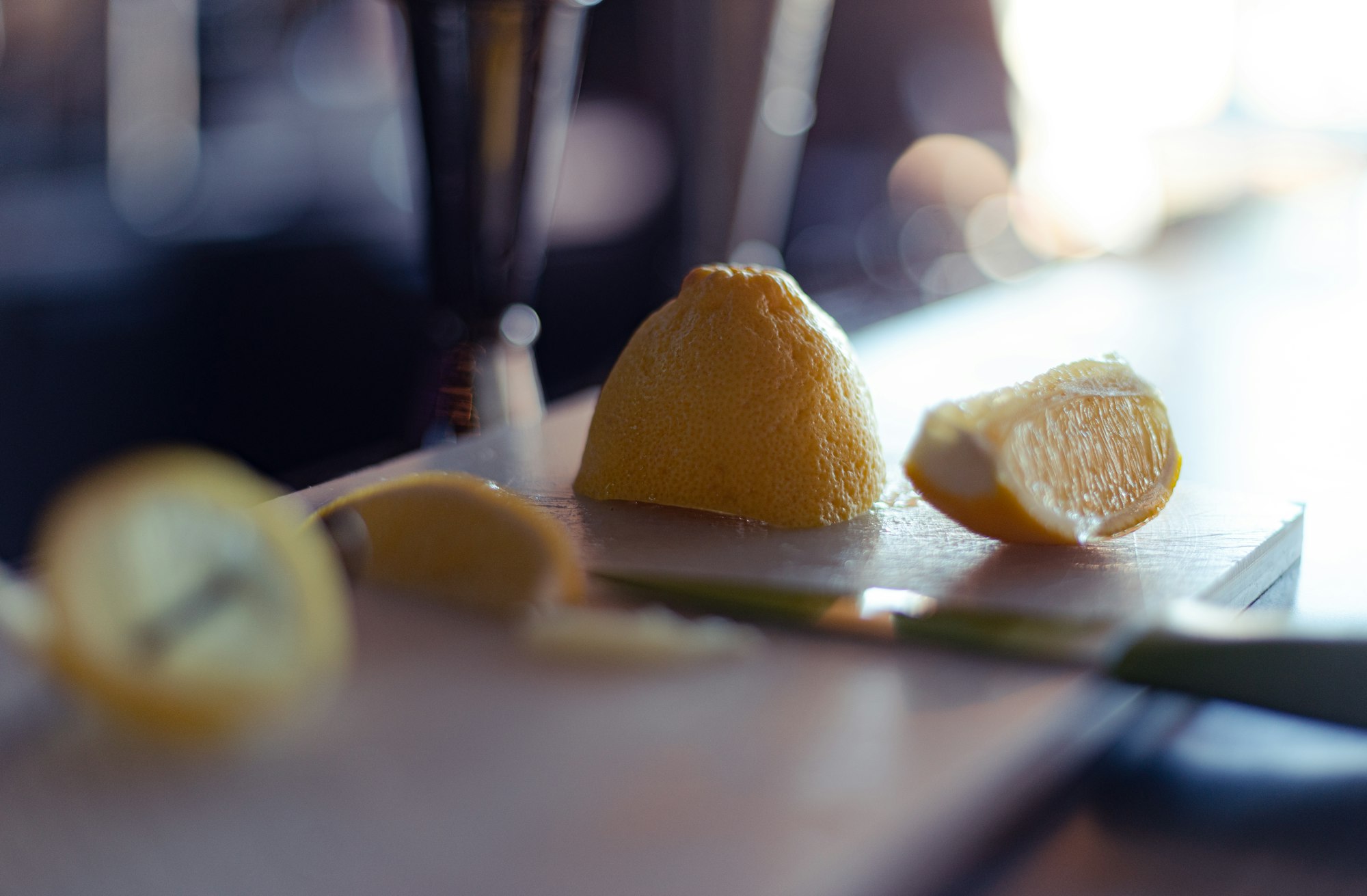 Lemons sliced at a bar counter in preparation for a Christmas cocktail drink.