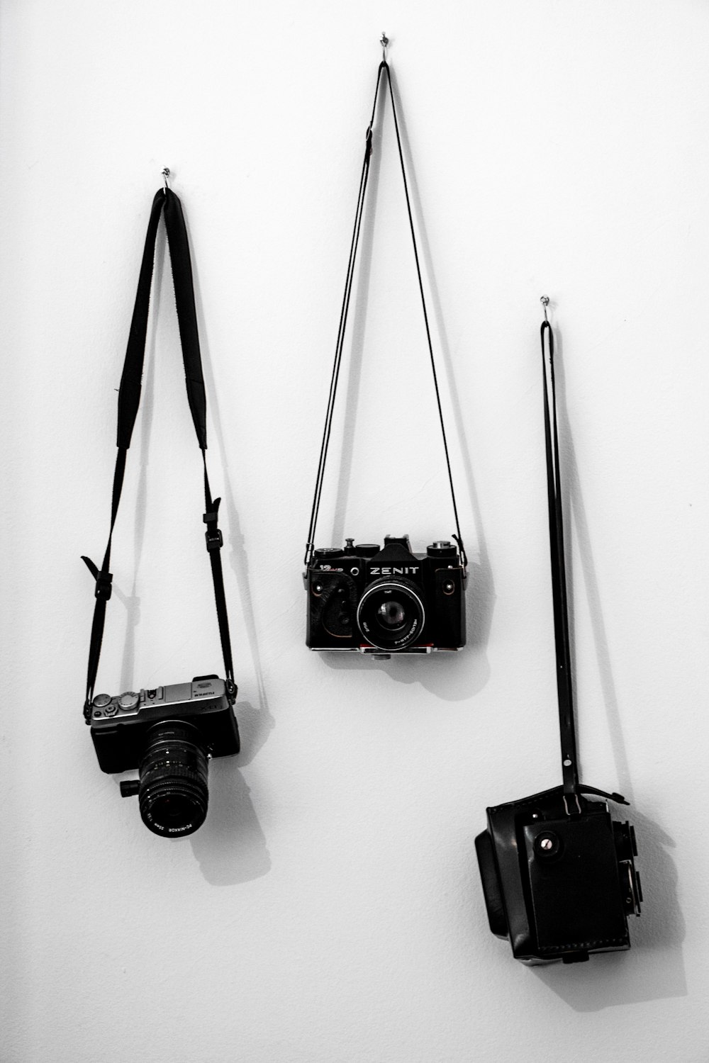 black dslr camera on white wall