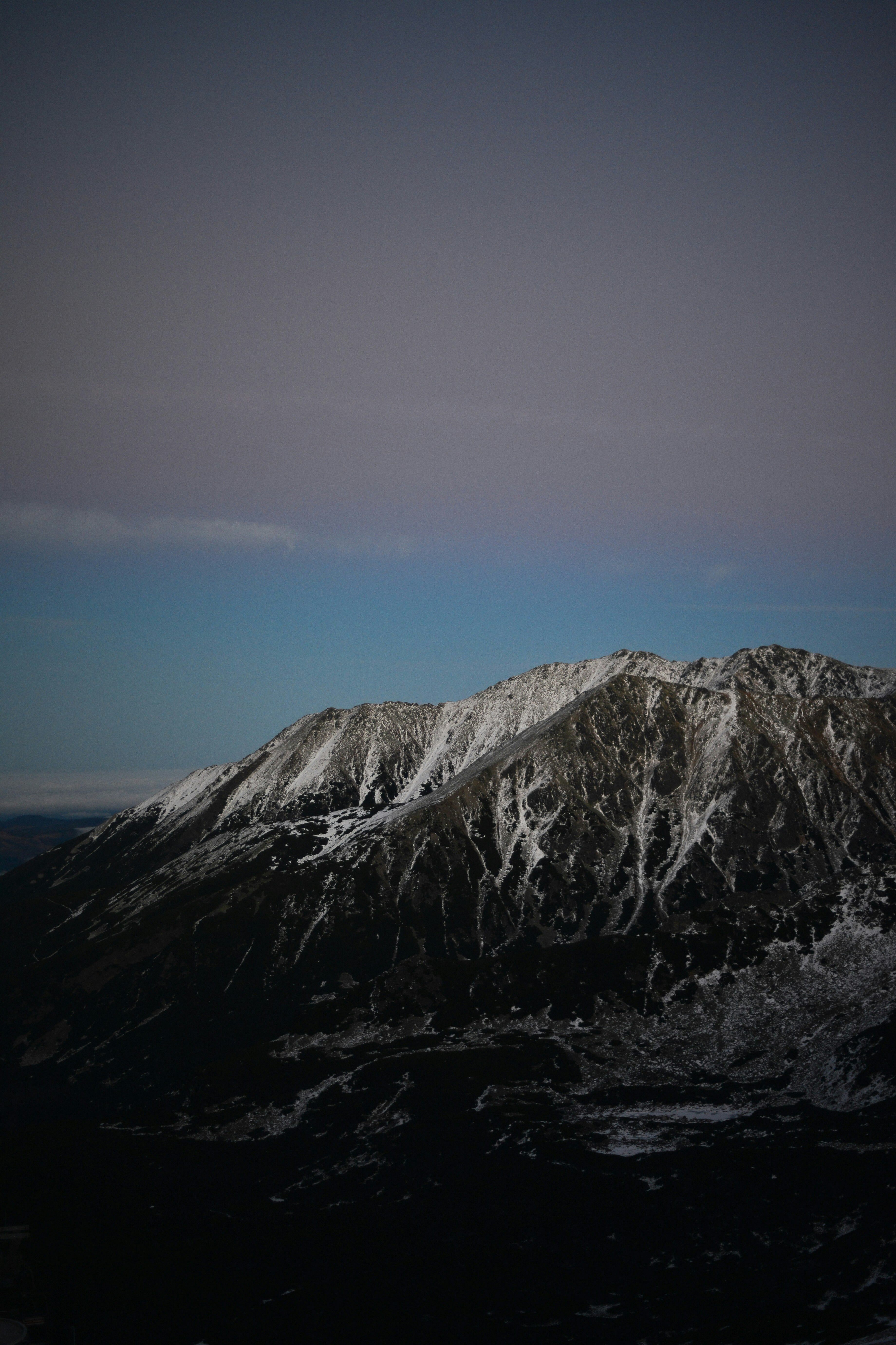 gray and white mountain under blue sky during daytime